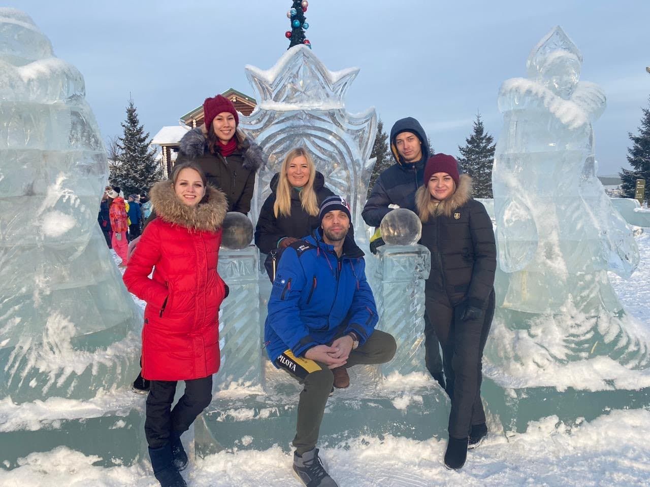 group of people standing on snow covered ground